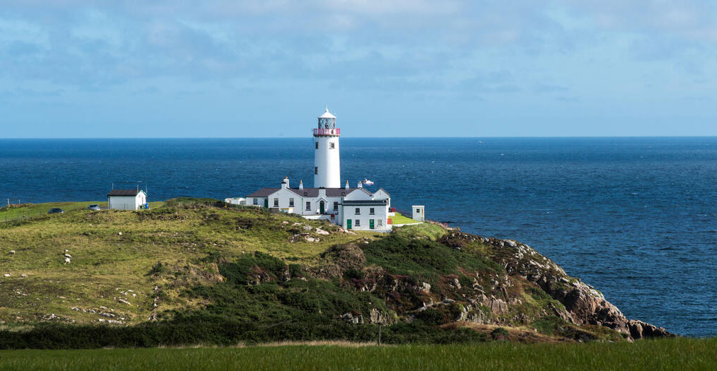 Fanad Head Lighthouse on a grassy Donegal headland, overlooking the Atlantic along the Wild Atlantic Way